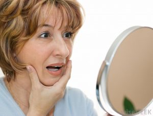 older-woman-looking-in-mirror-with-hand-on-chin